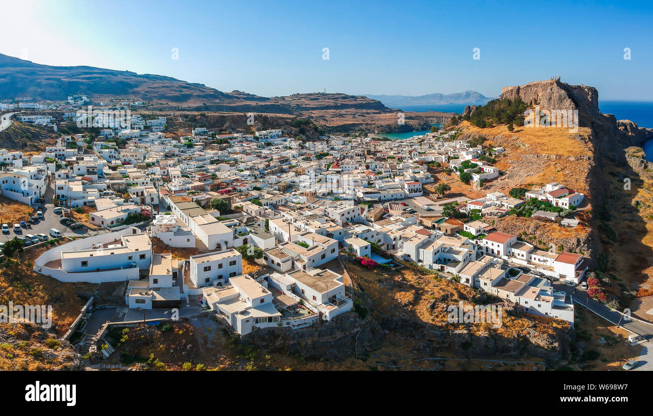 Antenne Birds Eye View drone Bilder Dorf Lindos, Insel Rhodos, Dodekanes, Griechenland. Sonnenuntergang Panorama mit Burg, Mittelmeer Küste. Berühmte t Stockfoto