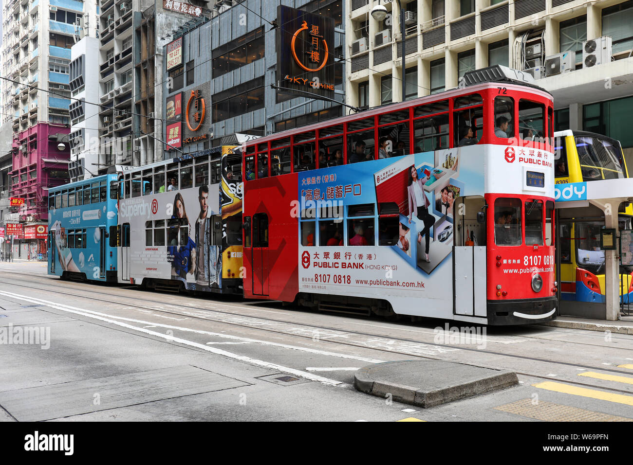 Drei doppelstöckigen Straßenbahnen auf eine Straßenbahnhaltestelle in der Sai Wan district, Hongkong Stockfoto