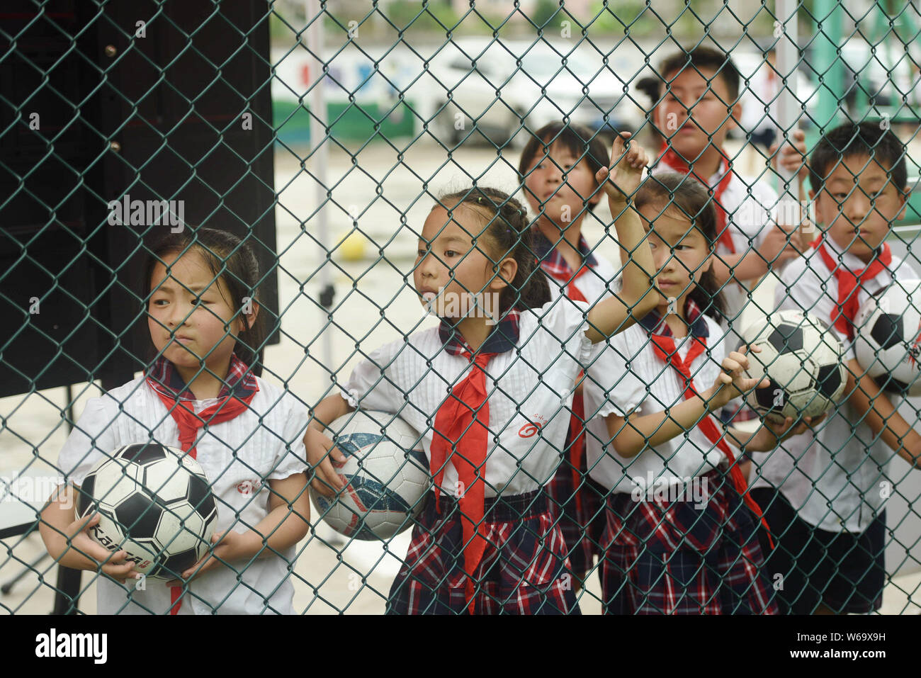 Junge chinesische Studenten sehen die Endrunde von "Hoffnung Projekt "Grundschule Fußballspiel auf der ersten ream Fußballplatz 'd' in der Shu'an Hoffnung Primäre Stockfoto