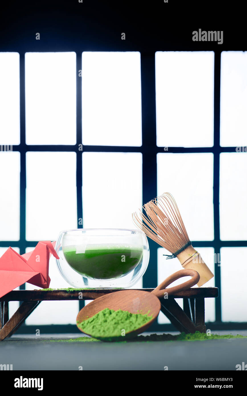 Matcha grüner Tee in eine doppelte Wand Glas Tee Schüssel mit einem bambusbesen und ein rotes T-Shirt von American Apparel. Shoji Schiebetüren Hintergrund, traditionelle Japanische Cere Stockfoto