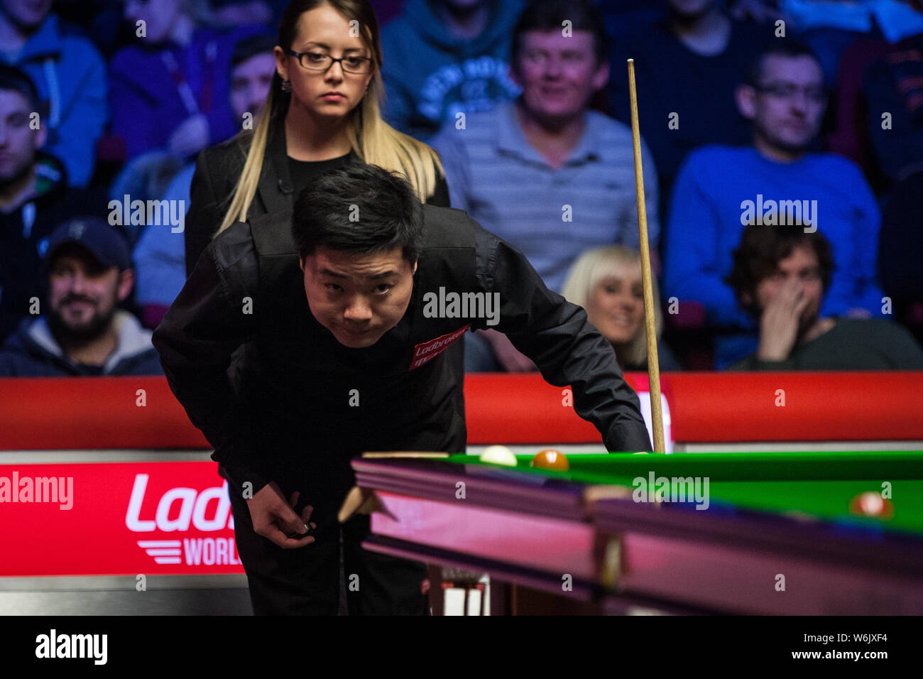 Ding Junhui von China hält einen Schuß zu Mark Selby von England in ihrem Halbfinale während der 2018 Ladbrokes World Grand Prix snooker Turnier Stockfoto