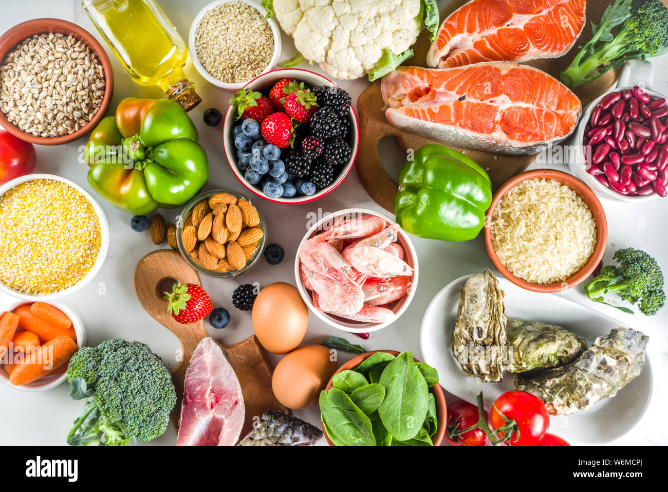 Pescetarian Diätplan Zutaten, gesunde und ausgewogene Lebensmittel essen, frisches Obst, Beeren, Fisch und Schalentiere Venusmuscheln, weißem Marmor Background Copy space Stockfoto