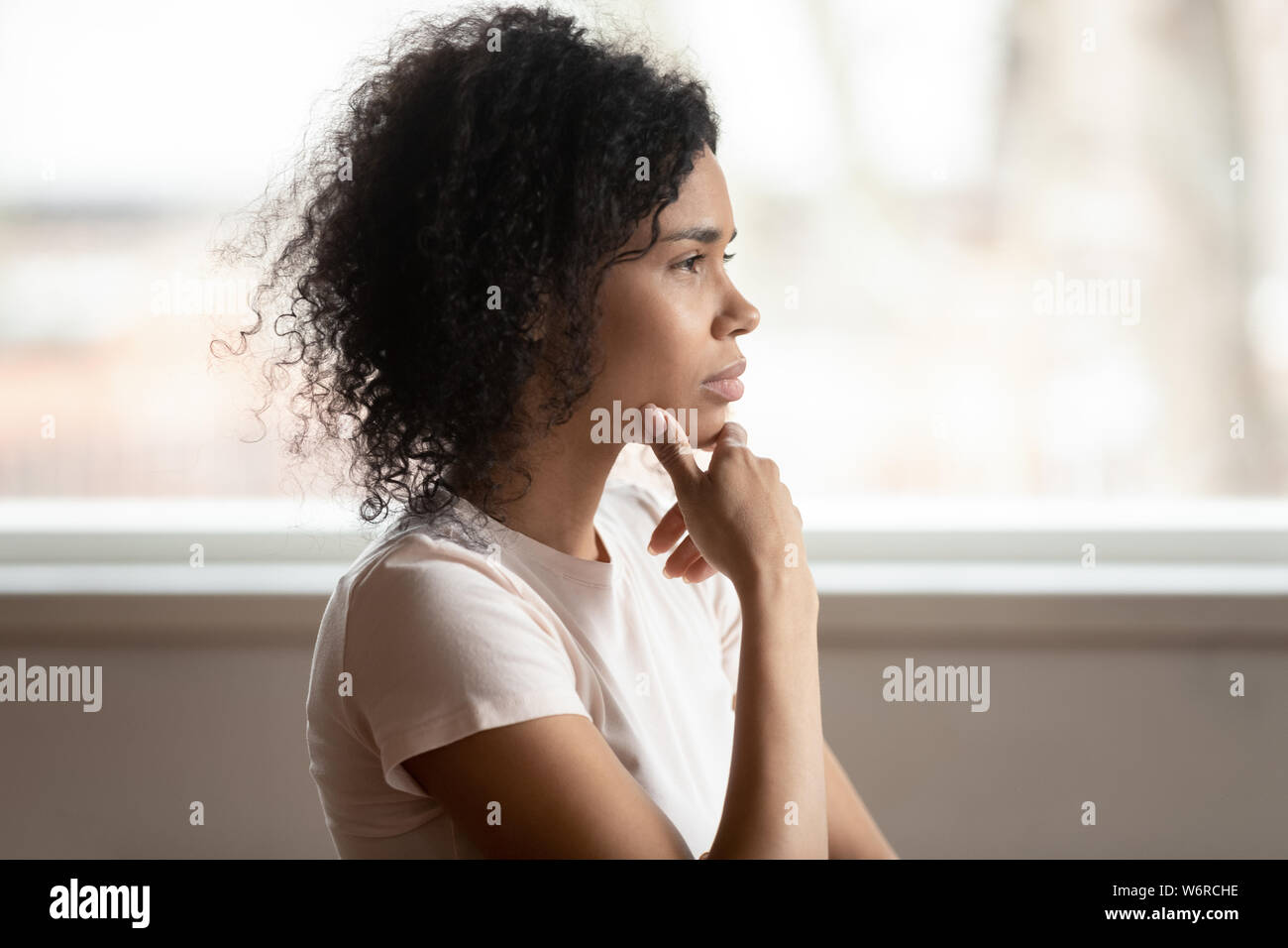 Nachdenklich gemischten Rasse Frau denken macht die Entscheidung, Seitenansicht Stockfoto