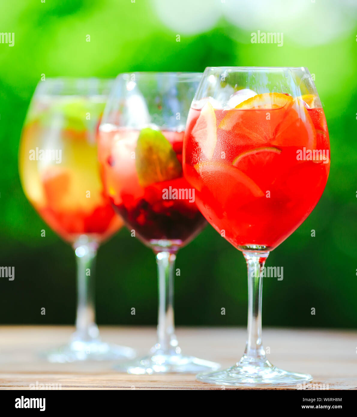 Sommer Cocktail. Fruchtcocktail auf grünem Hintergrund. Zitrusfrüchte, Beeren, Erdbeeren, Heidelbeeren, Minze, Eis Stockfoto