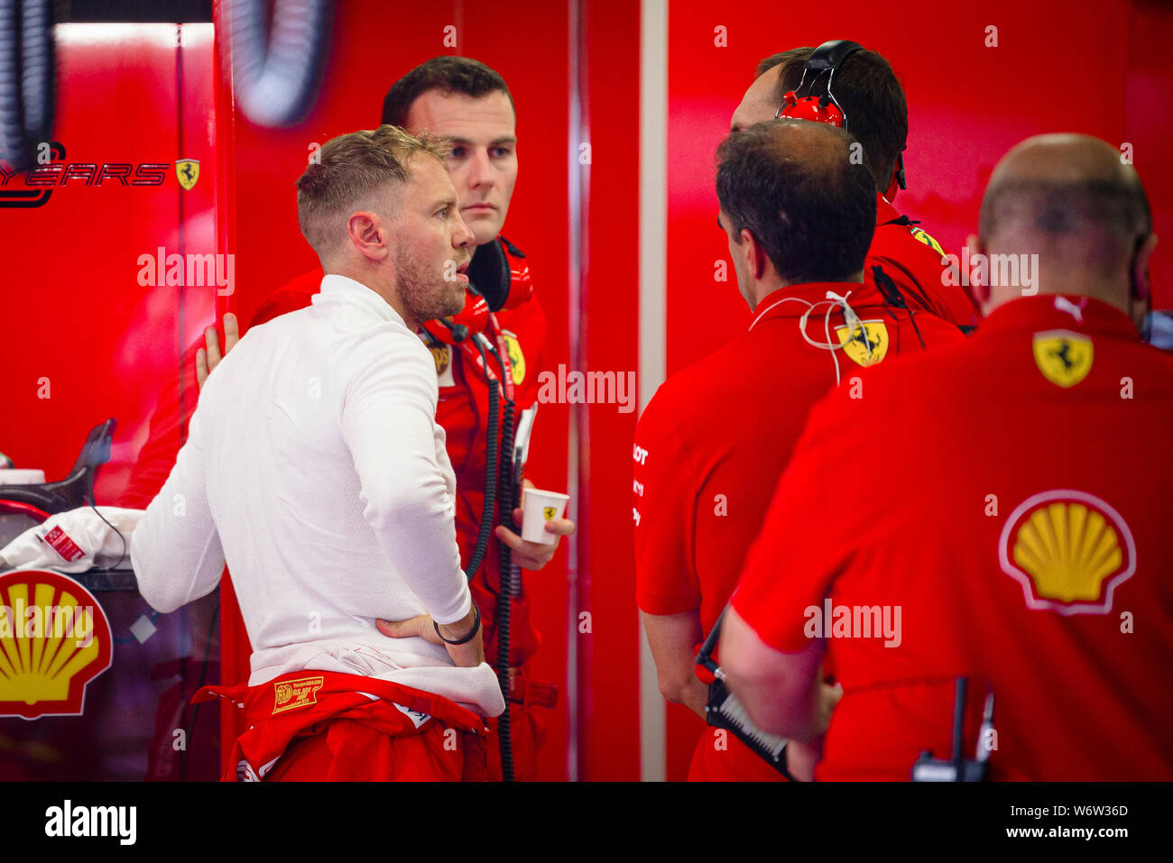 Scuderia Ferrari der Deutschen Fahrer Sebastian Vettel spricht mit der Mechanik nach dem zweiten Training der Ungarischen F1 Grand Prix. Stockfoto