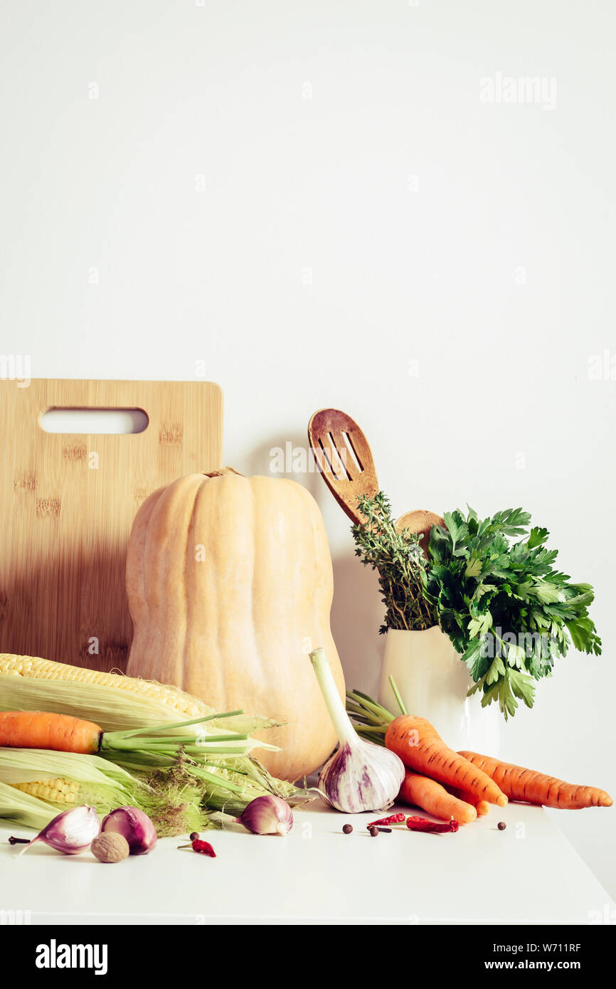 Herbst Gemüse und Geschirr auf dem Tisch Wand Hintergrund. Saisonale Gerichte Konzept. Stockfoto