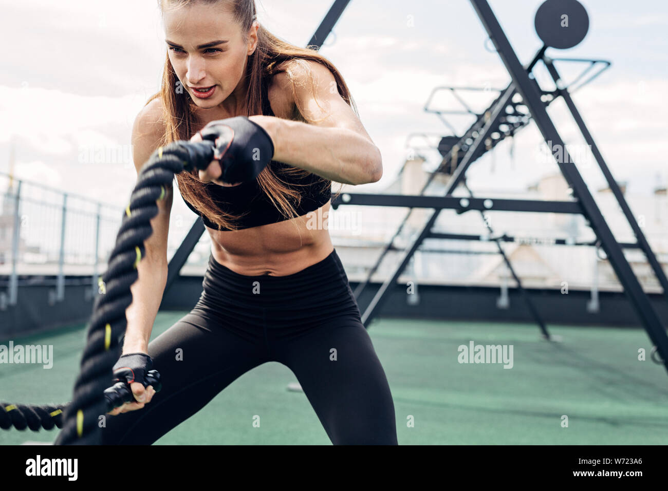 Frau tun Fitness Training mit Schlacht Seile auf im freien Fitnessraum Stockfoto