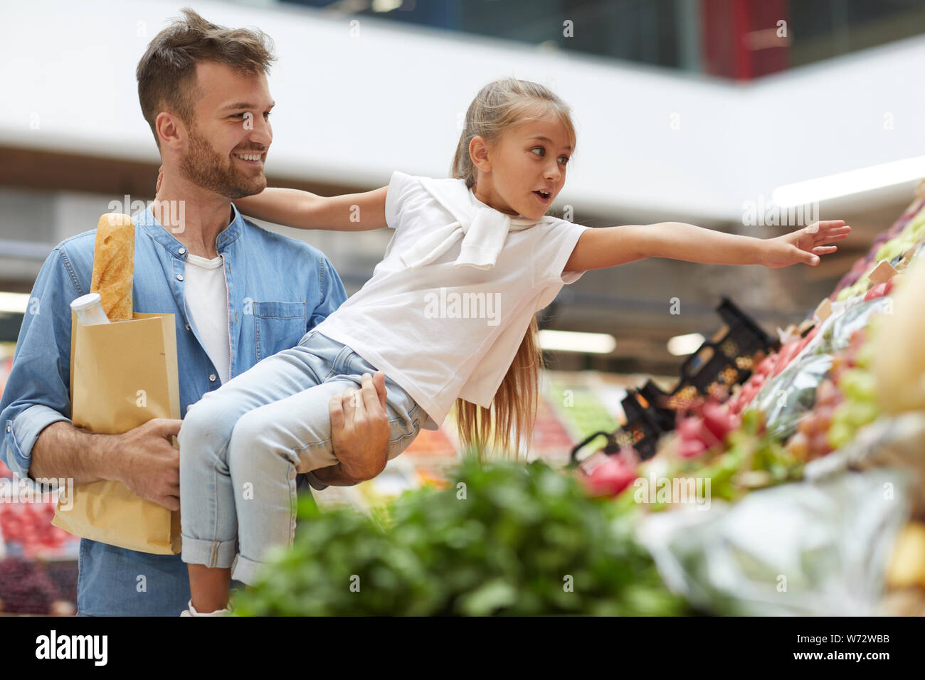 Portrait von niedlichen kleinen Mädchen erreichen für Gemüse und genießen Einkaufen mit Vati an Farmers Market, Kopie Raum Stockfoto