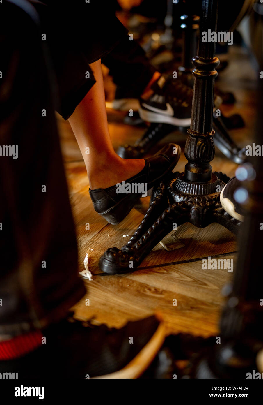 Nahaufnahme Beine von einem Mann und einer Frau unter den Tisch im Café. Vintage Style Tisch im Restaurant. Menschen Chill-out in der Coffee Shop im Urlaub. Stockfoto