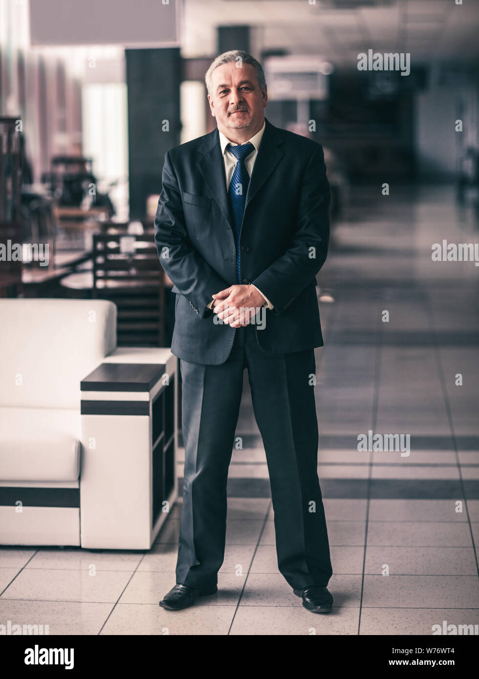 Portrait im vollen Wachstum - ein erfolgreicher Geschäftsmann auf dem Hintergrund der modernen Büro Stockfoto