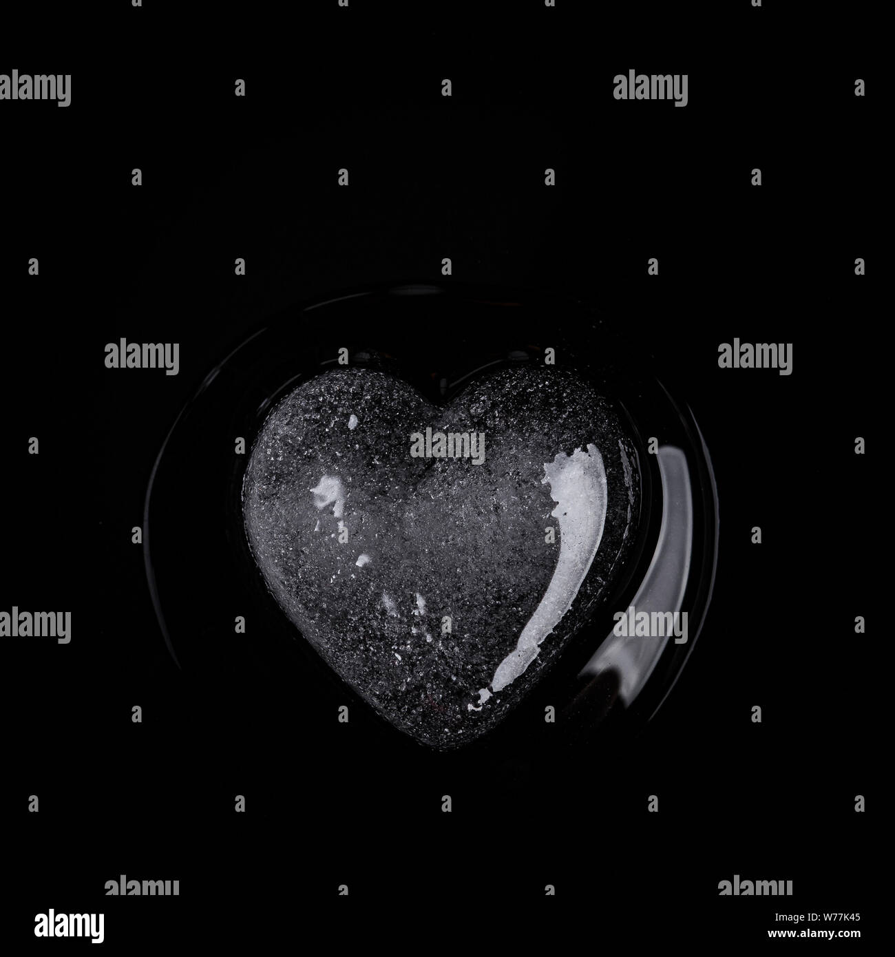 Herzförmige ice Rock in der Nähe auf einem schwarzen Hintergrund Stockfoto