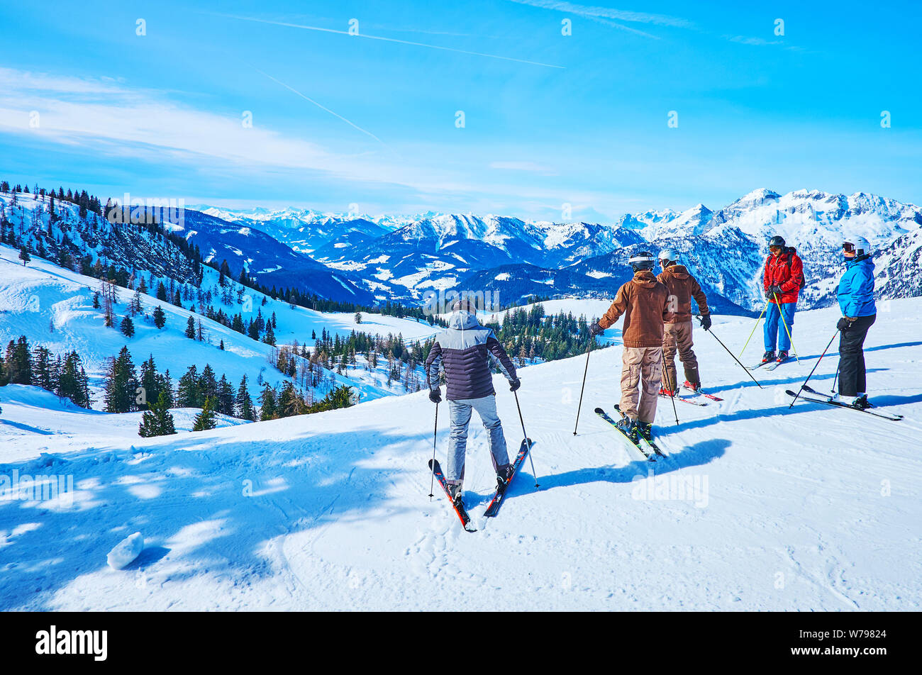 GOSAU, Österreich - Februar 26, 2019: Die Gruppe der Skifahrer die Abfahrt von der Oberseite der Zwieselalm Berg beginnt, umgeben durch verschneite Gipfel der Dachstei Stockfoto
