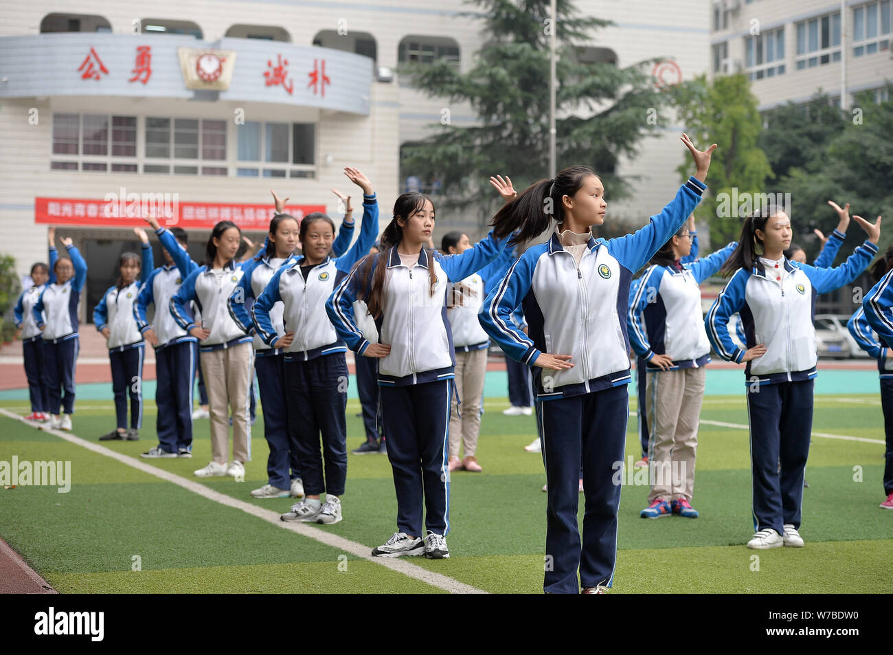 Die Teilnehmer führen Sichuan Oper inspirierte Calisthenics, erstellt von Sichuan Oper Meister Peng Denghuai, an einer High School in Chengdu City, im Südwesten von China Stockfoto