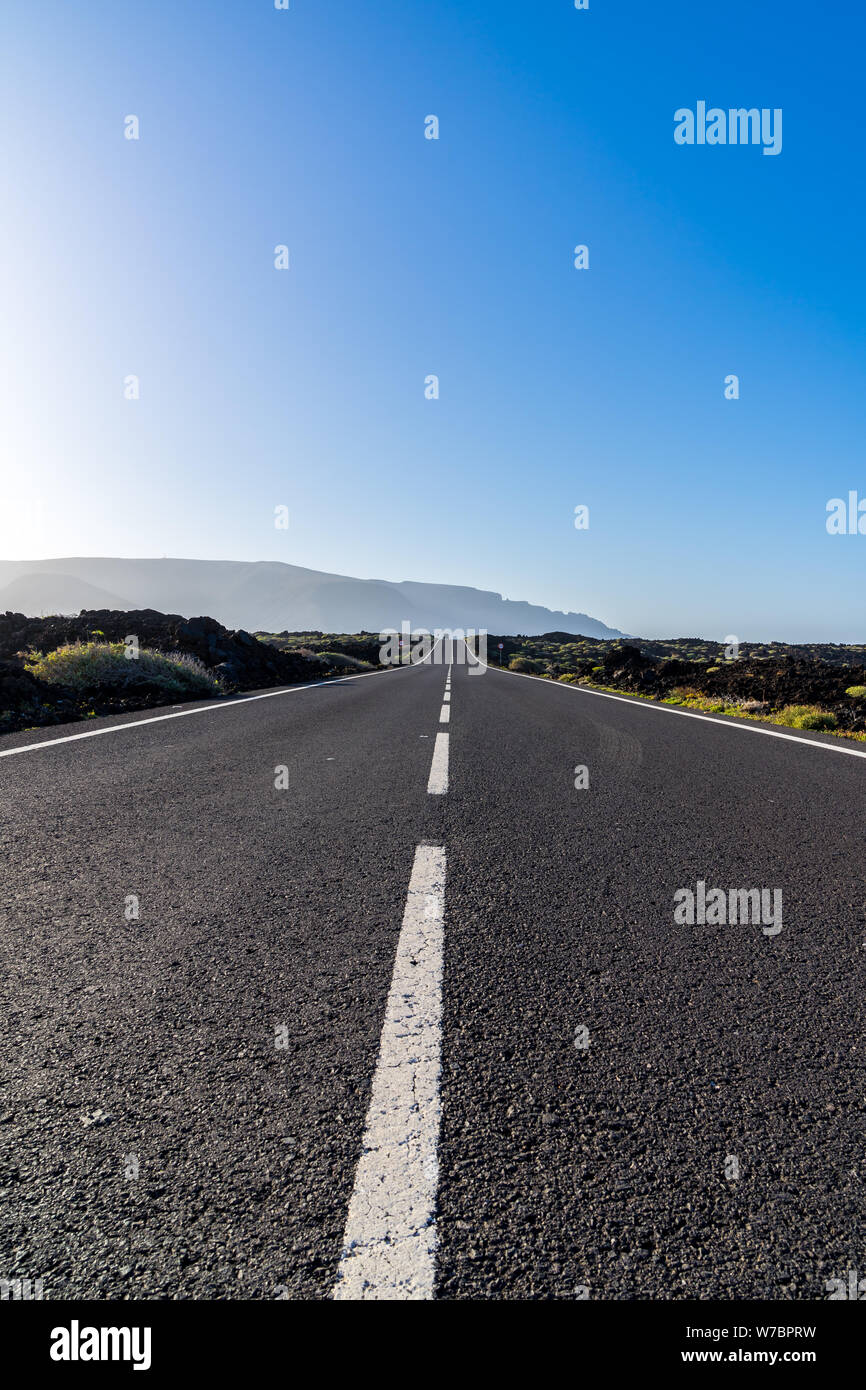 Spanien, Lanzarote, endlose perfekt asphaltierte Straße durch das Schwarze Lavafelder vulkanische Insel Stockfoto