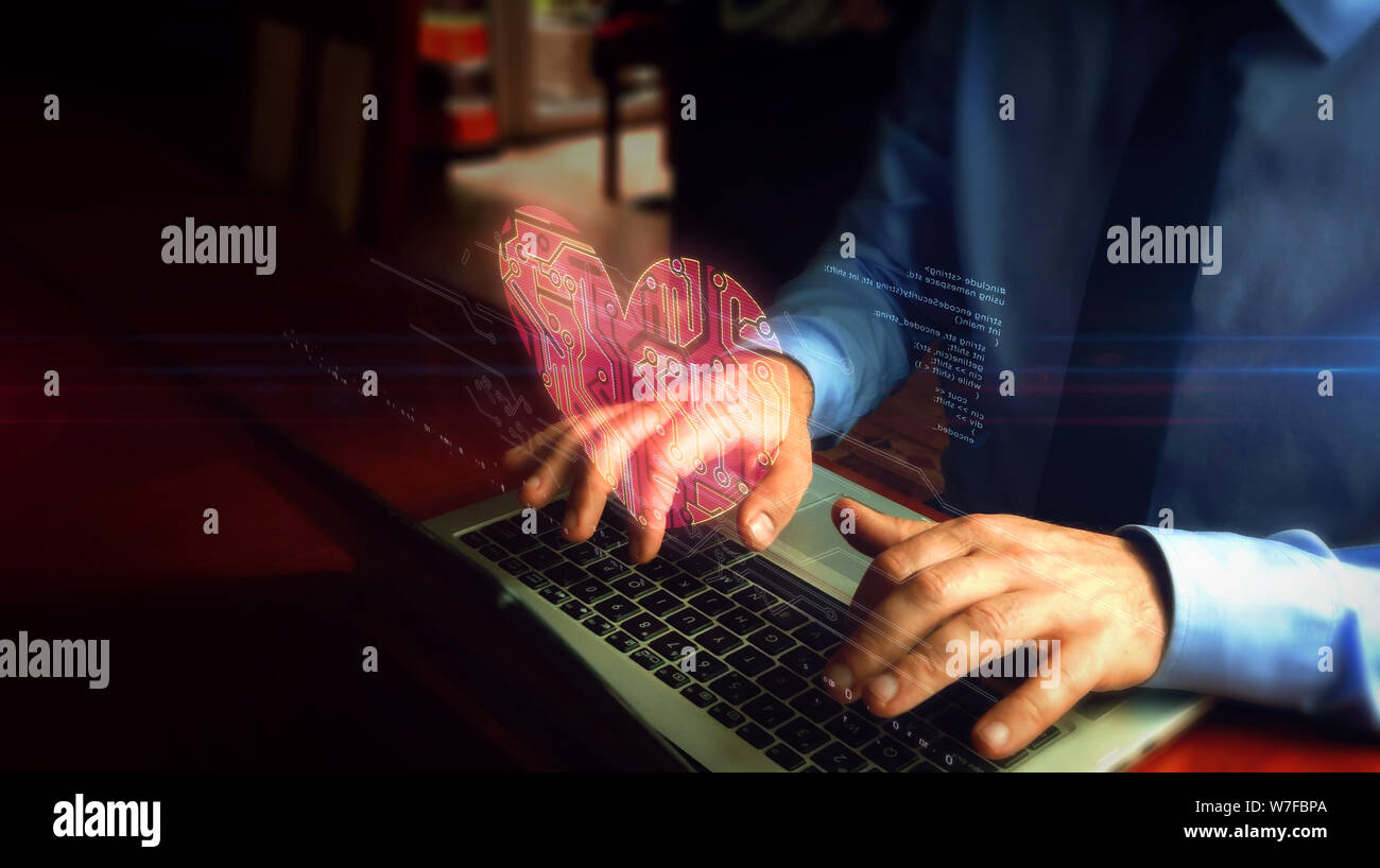 Man tippt auf Laptop mit Kybernetischen herzen Hologramm-Bildschirm über die Tastatur. Liebe, cyber dating , Gesundheit und Kardiologie futuristisches Konzept. Natu Stockfoto