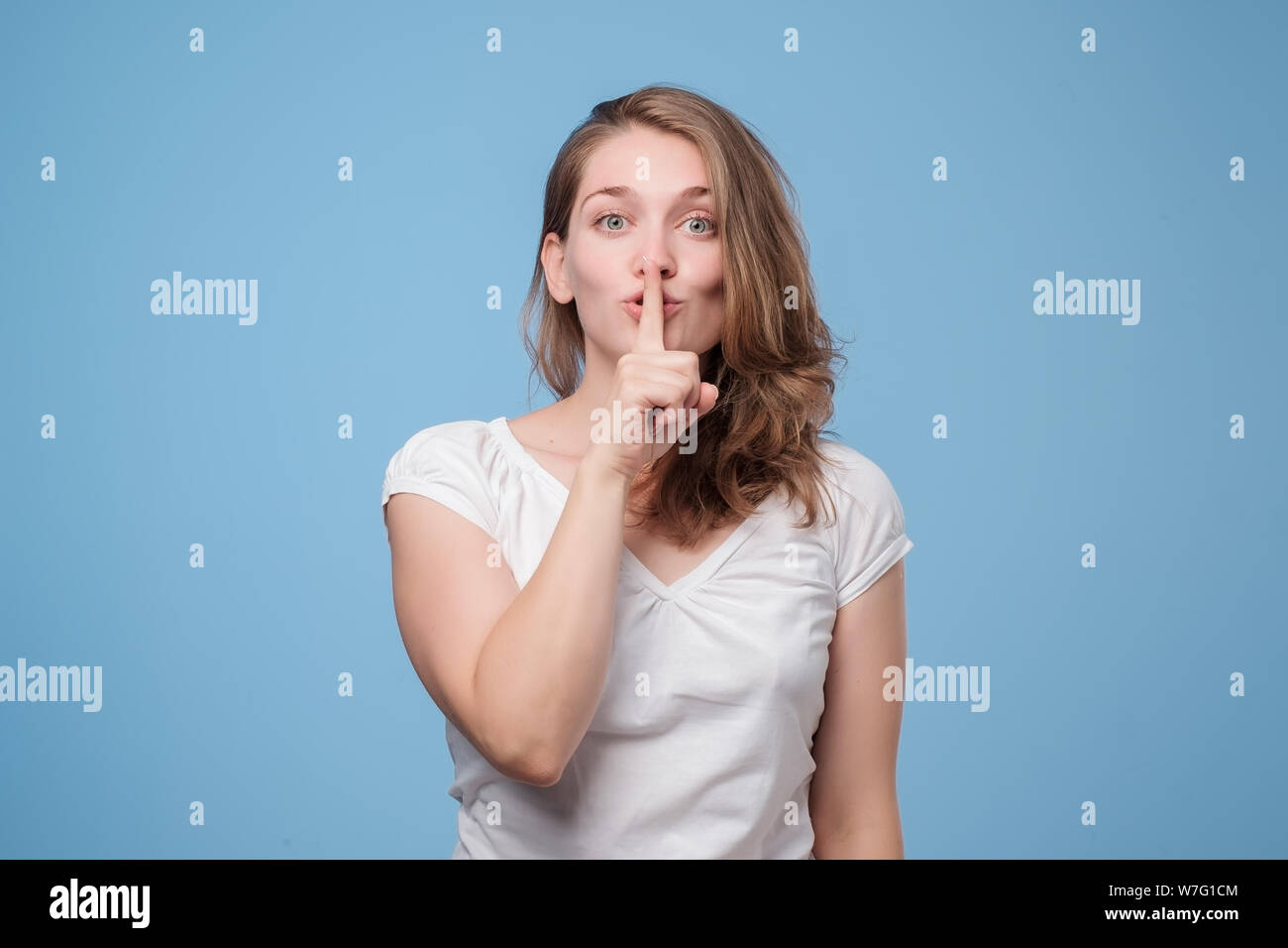 Still, still zu sein. Ernsthafte schöne Frau fragt geheime Informationen vertraulich zu behandeln. Verschwörung Konzept Stockfoto