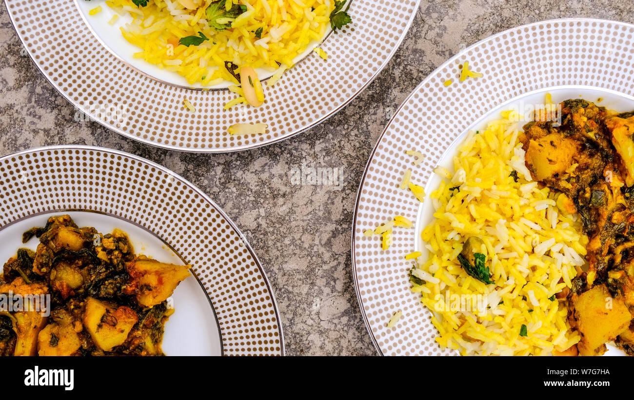 Im indischen Stil vegetarische Aloo Gobi Saag, Kartoffeln, Blumenkohl und Spinat in pikanter Soße mit Reis Stockfoto