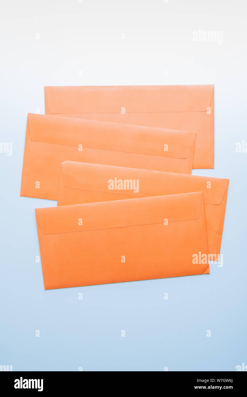 Orange Umschläge in weißer Hintergrund, Ansicht von oben. Abstraktes Bild der post Paket, Konzept der Kommunikation und Mailinglisten. Stockfoto