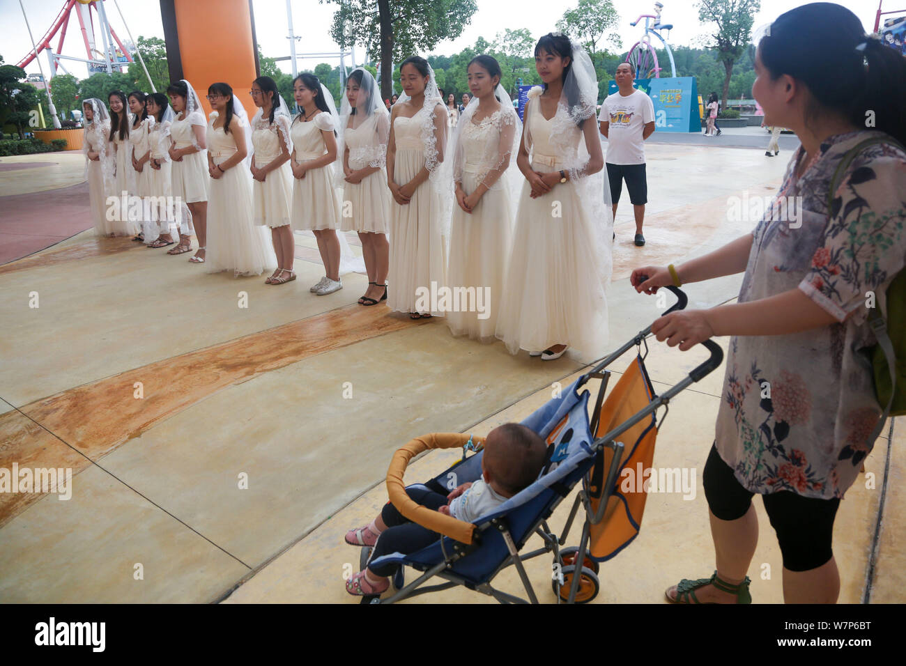Bräute Brautkleider sind eine Gruppe Trauung für Paare der schulfreund Liebhaber aus einer Universität Wuhan Happy Valley Amusement Park gesehen Stockfoto