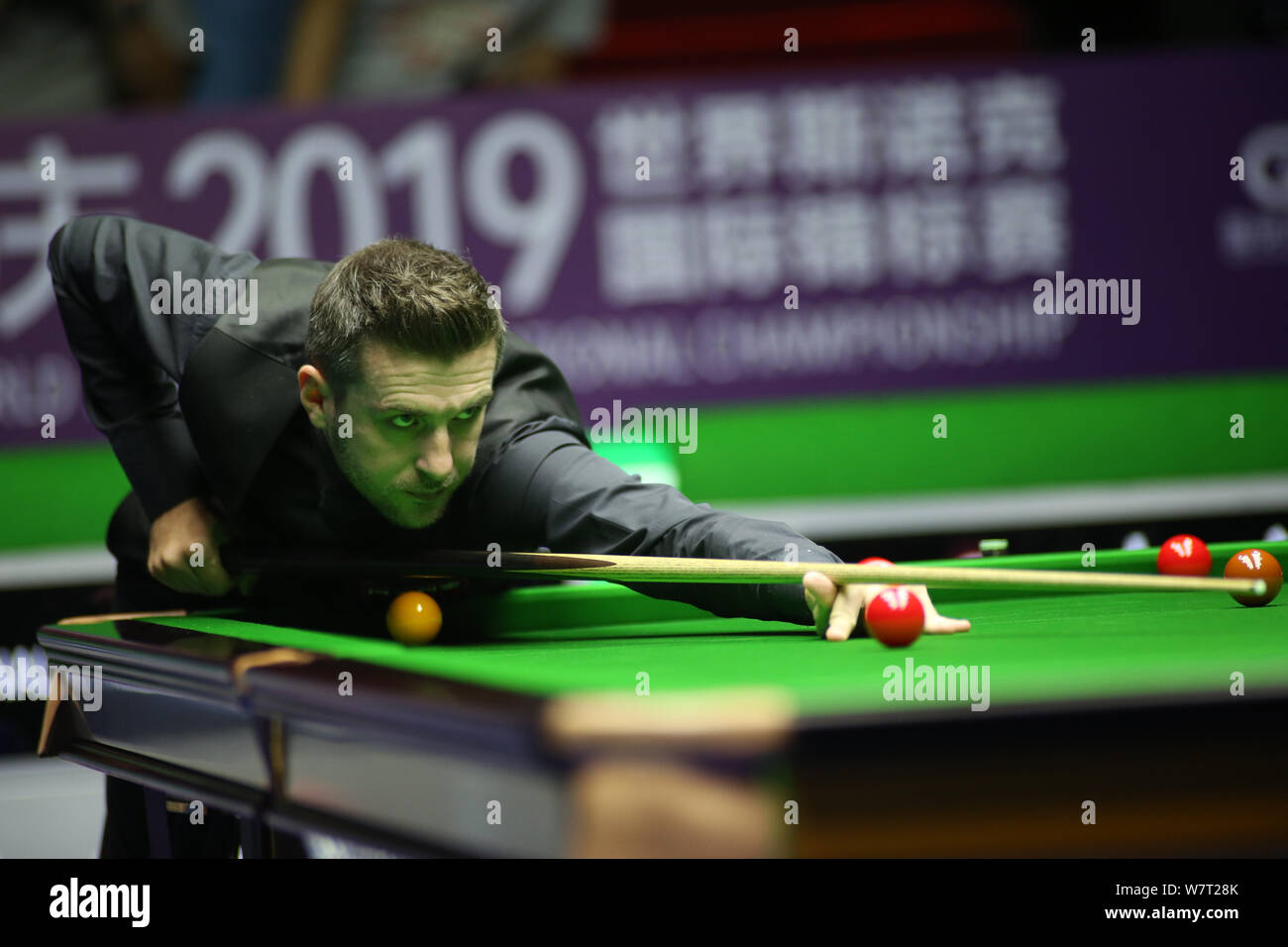 Mark Anthony Selby von England spielt einen Schuß zu Ben Woollaston Englands in der zweiten Runde während der 2019 World Snooker internationale Meisterschaft in Daqing Stadt, im Nordosten der chinesischen Provinz Heilongjiang, den 6. August 2019. Stockfoto