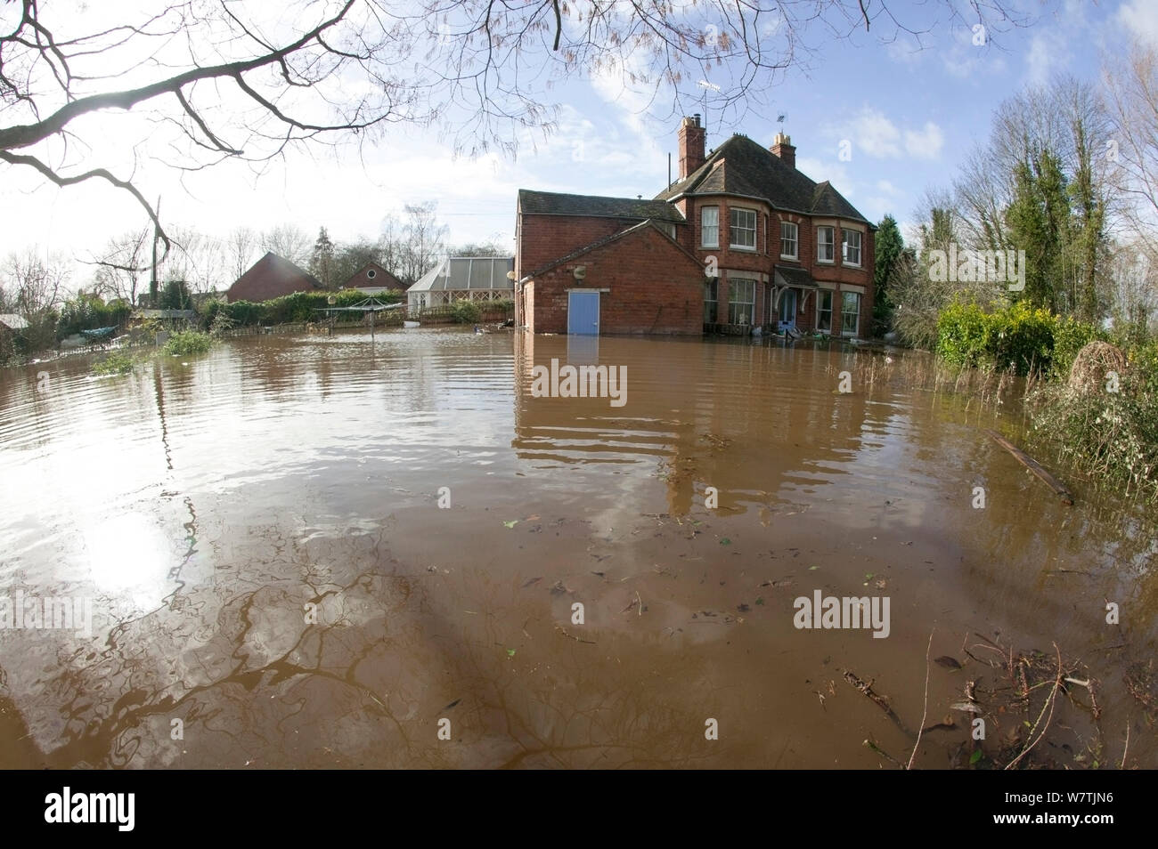 Home bis Februar Überschwemmungen 2014 mit Detritus rund um Garten überschwemmt, Upton bei Severn, Worcestershire, England, UK, 9. Februar 2014. Stockfoto