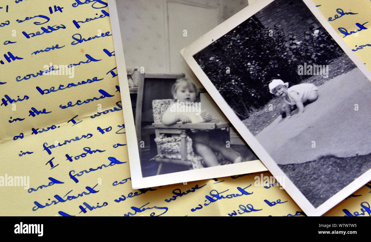 Alte schwarz-weiß Fotografien der Babys, die auf handschriftlichen einen alten 1940er schreiben Stockfoto