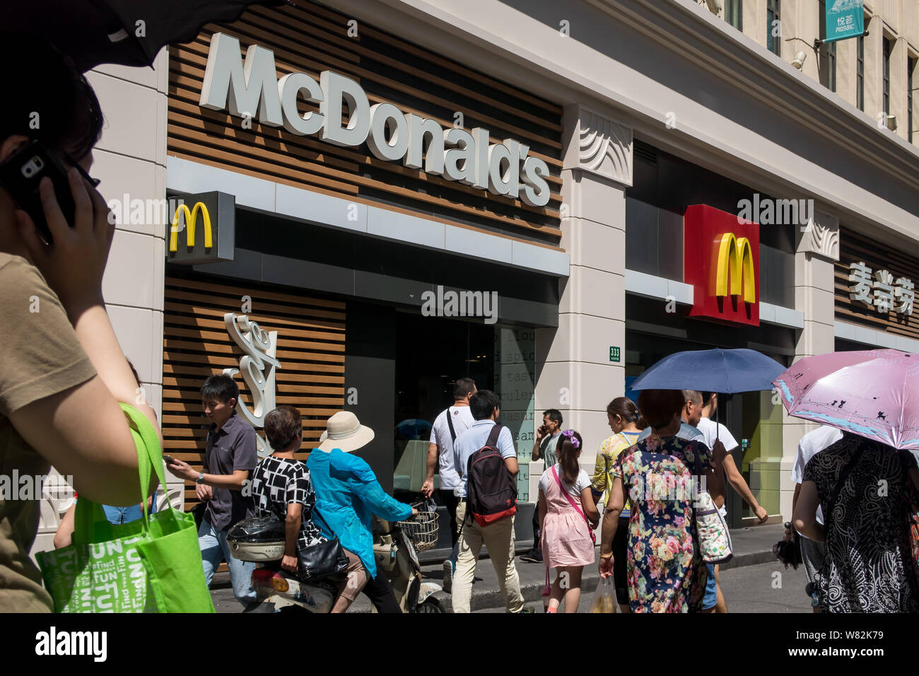 ---- Fußgänger vorbei ein Fastfood Restaurant von McDonald's in Shanghai, China, 15. August 2016. Die Hong Kong Bund der Gewerkschaften (H Stockfoto