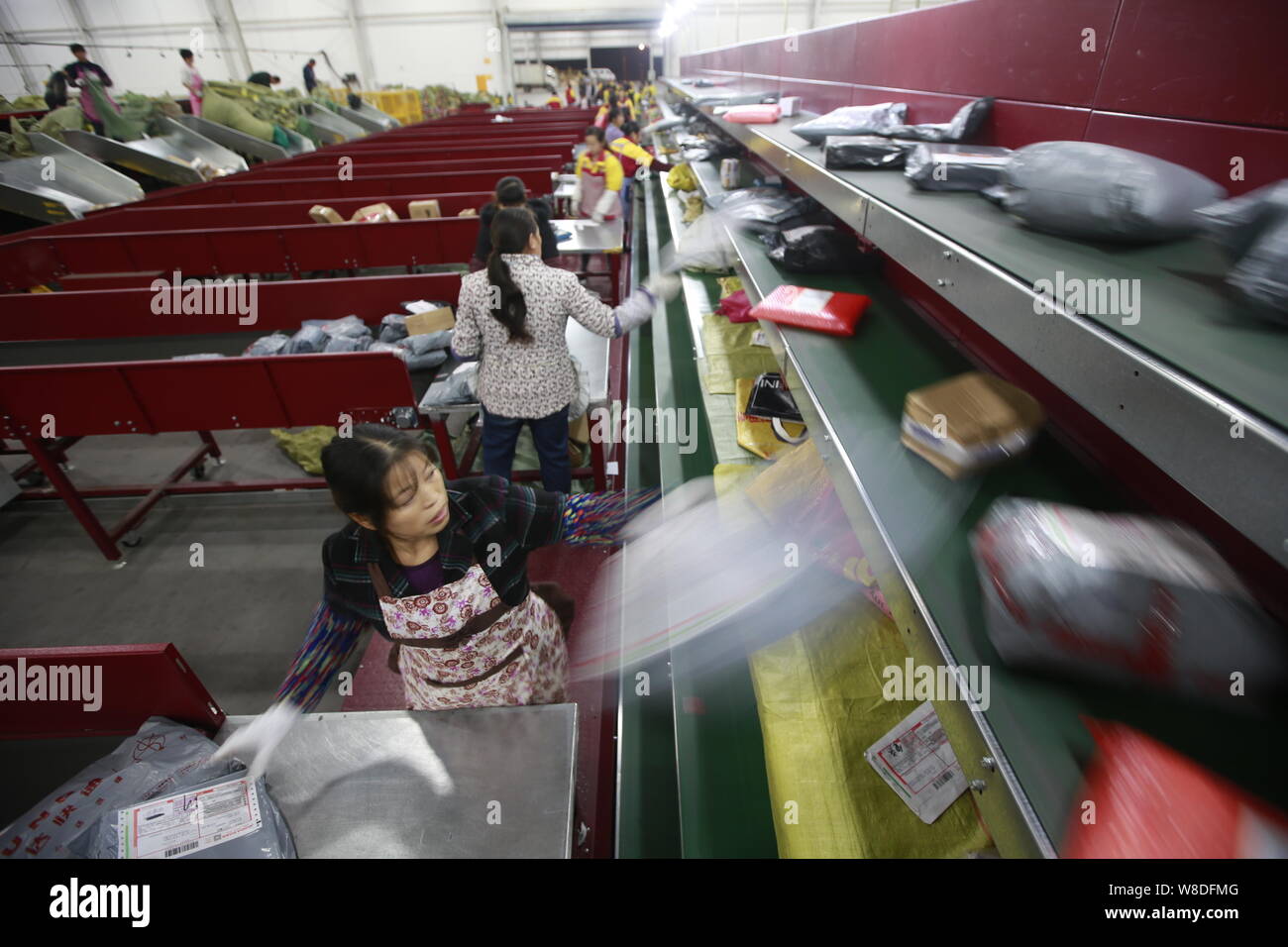 Chinesische Arbeiter sortieren Pakete, von denen die meisten aus online einkaufen, bei einer Distribution Center von Yunda Express in Chongqing, China, 16. November 2015. Stockfoto