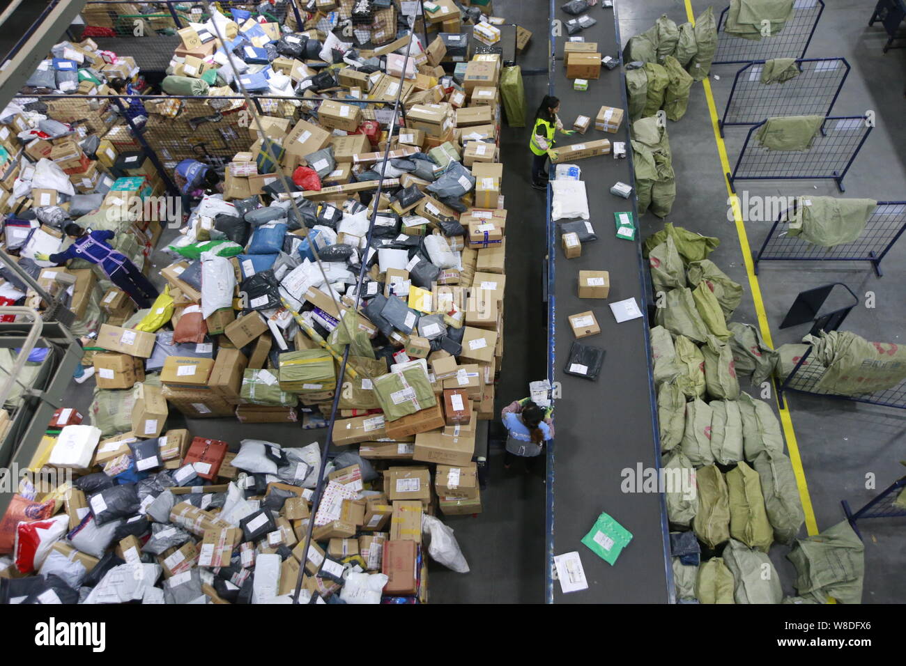 Die chinesischen Arbeiter Stapel Sortieren von Paketen, von denen die meisten aus online einkaufen, bei einer Distribution Center Best Express in Chongqing, China, 16 Novemb Stockfoto