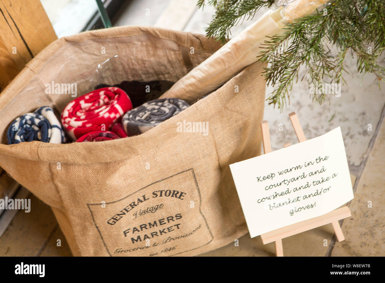 Wiederverwendbare Bauern vermarkten eine Tasche mit handgefertigten Wollartikeln, die nachhaltiges Einkaufen und rustikale handwerkliche Waren fördert. Stockfoto