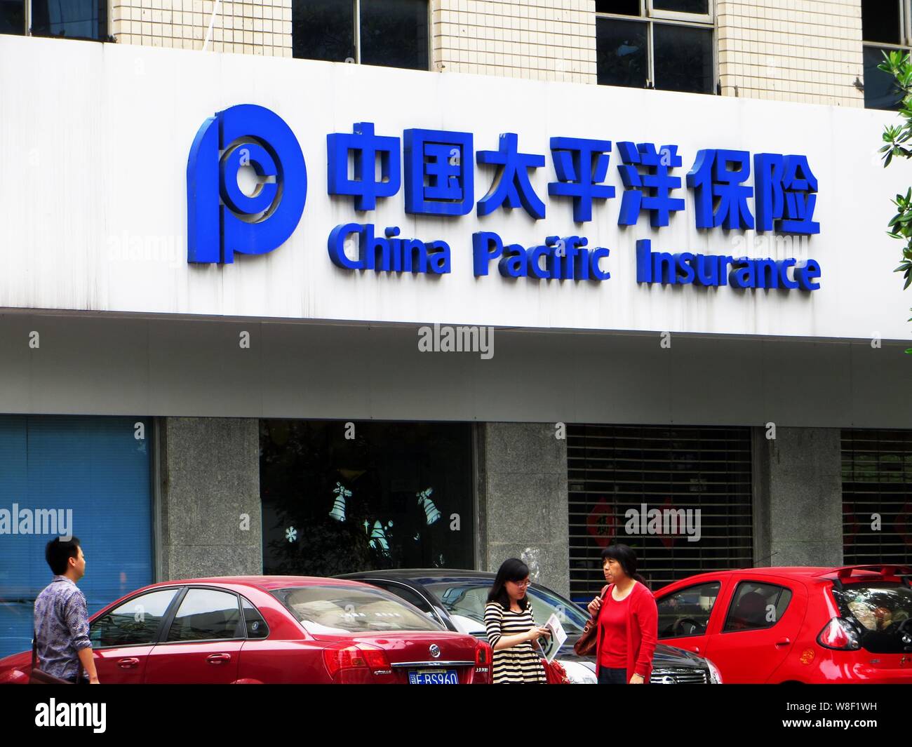 ---- Fußgänger vorbei an einem Zweig von China Pacific Insurance Company (CPIC) in Kunshan City, Central China Provinz Hubei, 2. Mai 2013. Allia Stockfoto