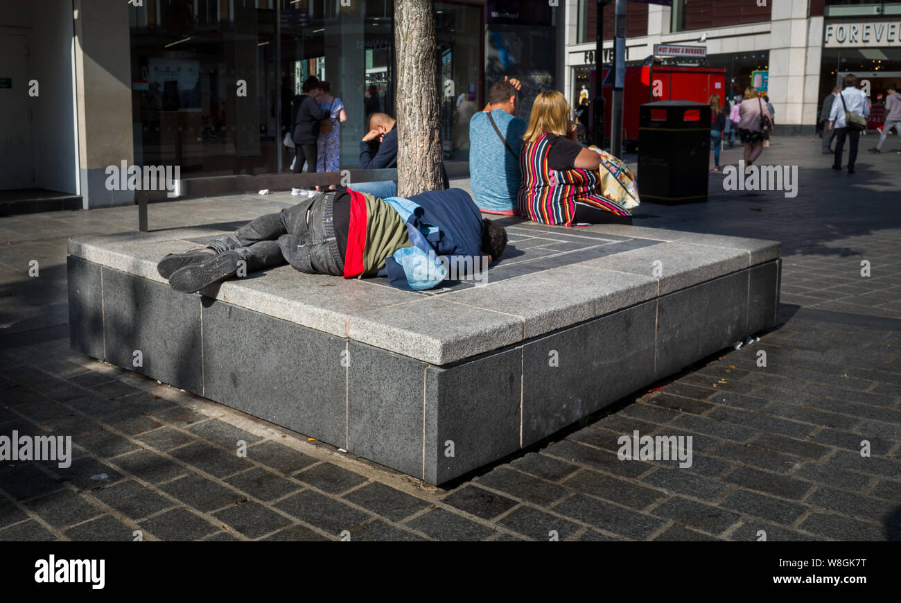 1. August 2019: Ein obdachloser Mann schläft unter Fußgänger und Käufern in Liverpool, Großbritannien. Stockfoto