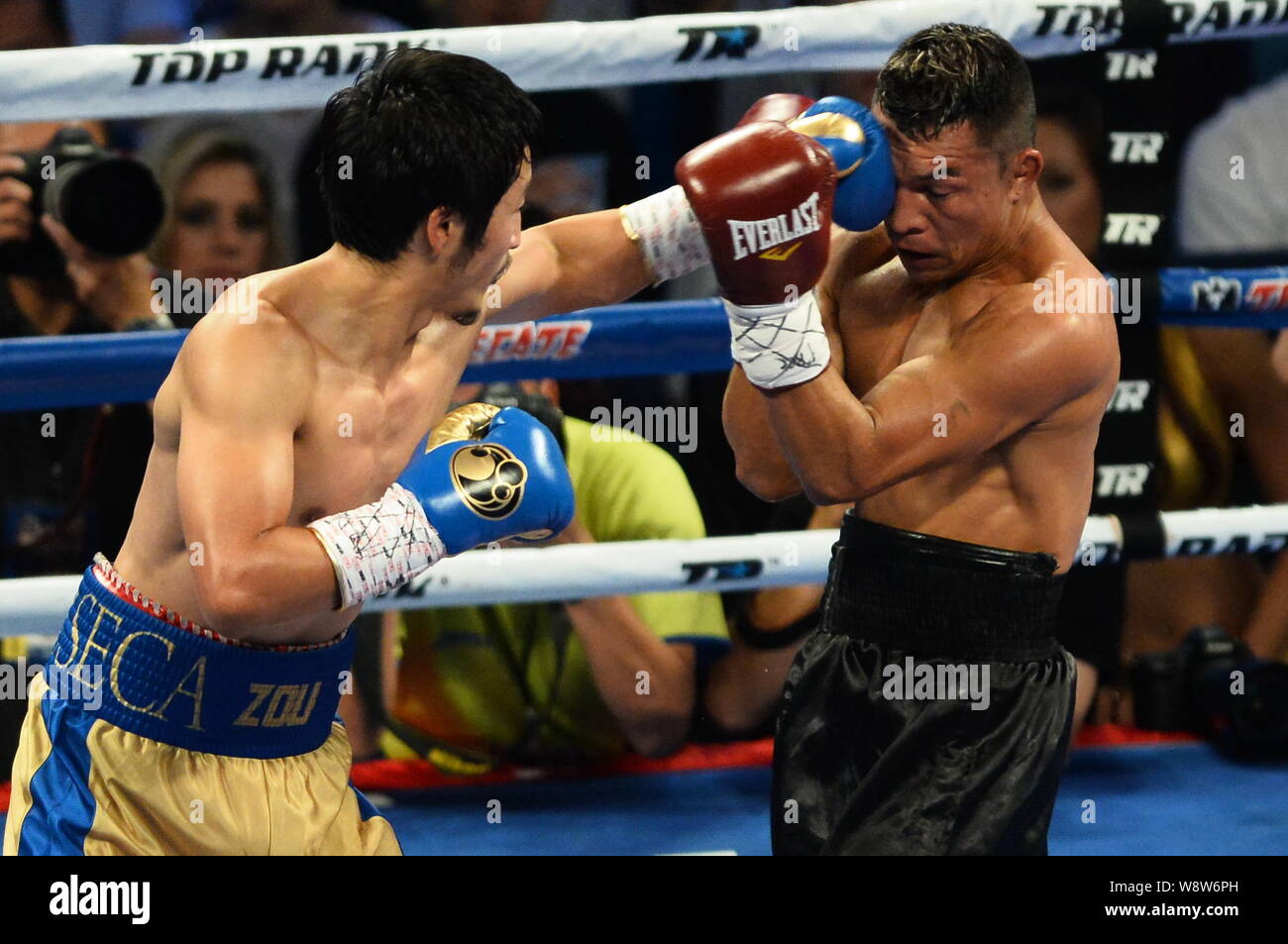 Zou Shiming von China, Links hits Luis De La Rosa von Kolumbien in Ihrem Fliegengewicht boxen Kampf während der Meister von Gold boxing Ereignis in Macau, China, Stockfoto