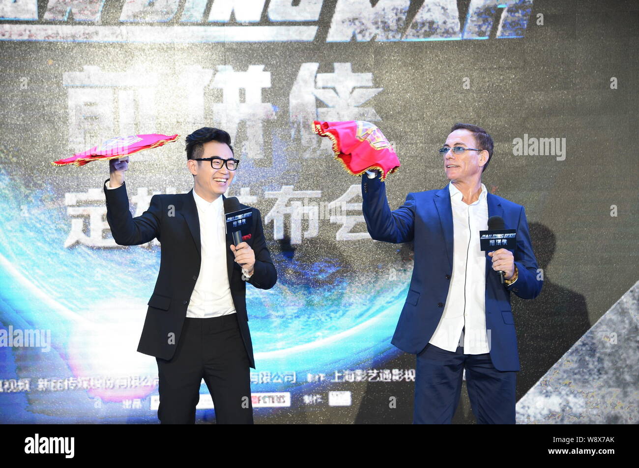 Usa Hollywood action star Jean-Claude Van Damme, rechts, dreht sich ein Taschentuch während einer Pressekonferenz für den Film "Der Pancake Man' in Peking, Stockfoto