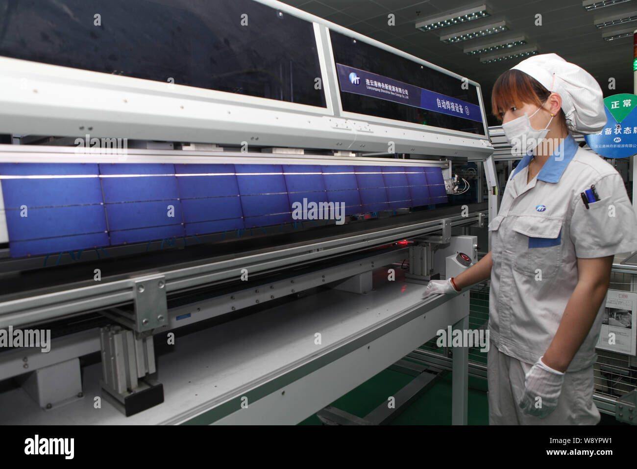 ---- Eine weibliche chinesischer Arbeiter überwacht die Produktion von Solarzellen für Solarmodule nach Europa und in die Vereinigten Staaten an der Anlage ausgeführt werden Stockfoto