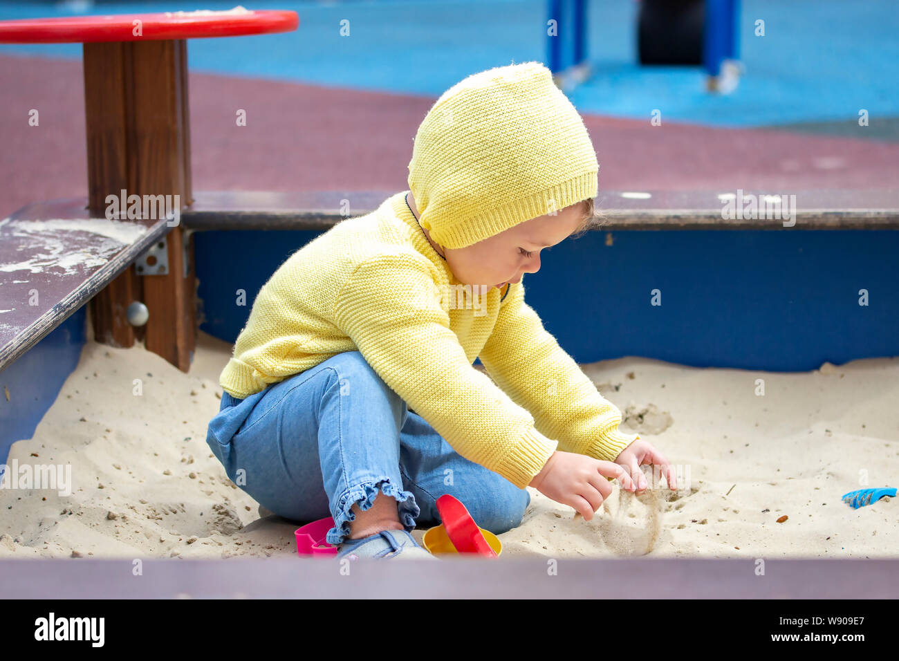 Kind, Mädchen, Junge europäische Spielen mit Sand im Sandkasten. Kind Baby  ein Jahr alt ist der Sand mit den Händen berührt, spielt auf dem  Spielplatz. Kind in Stockfotografie - Alamy
