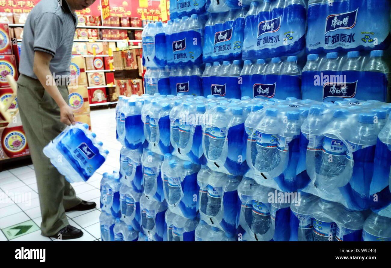---- Ein Kunde Geschäfte für Flaschen von Meister Kong mineralisiertes Wasser des Tingyi (Cayman Inseln) Holding Corp. in einem Supermarkt in Shanghai, China, 19. Stockfoto