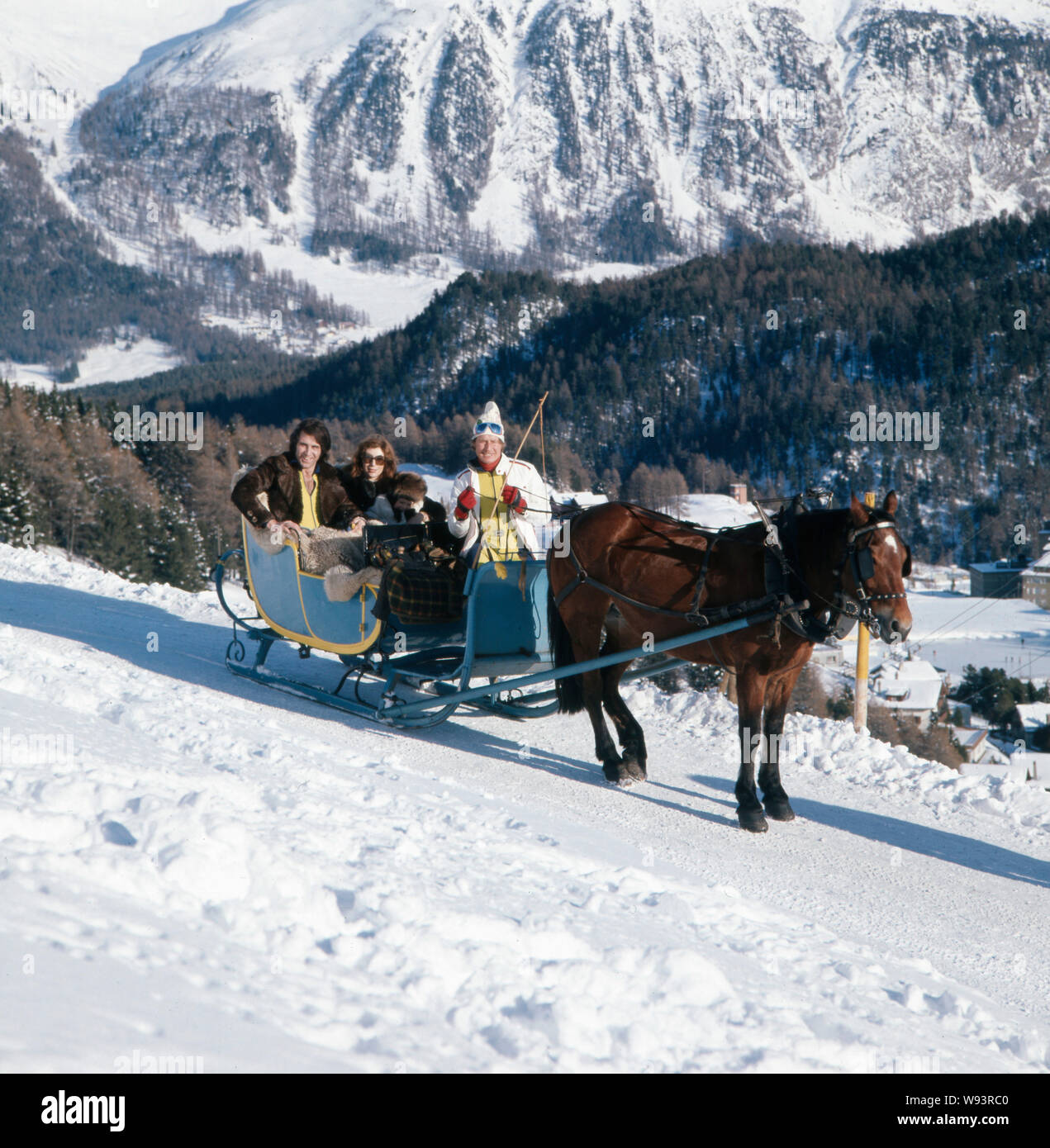 Der deutsche Sänger, Moderator, Songwriter und Gitarrist Peter Rubin bei einem Fotoshooting in den Bergen im Schnee mit seiner Familie im Schlitten, Anfang der 1970er Jahre. Die deutsche Sängerin, Moderatorin, Songwriter und Gitarrist Peter Rubin bei einem Shooting in den Bergen im Schnee mit seiner Familie in einem Schlitten in den frühen 1970er Jahren. Stockfoto