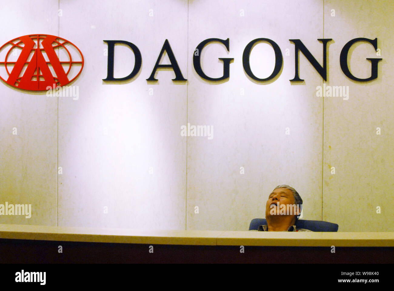Ein Mann nap an der Rezeption in der Zentrale der Dagong Global Credit Rating Co., Ltd., Peking, China, 28. Juli 2011. China Dagong Global Cred Stockfoto