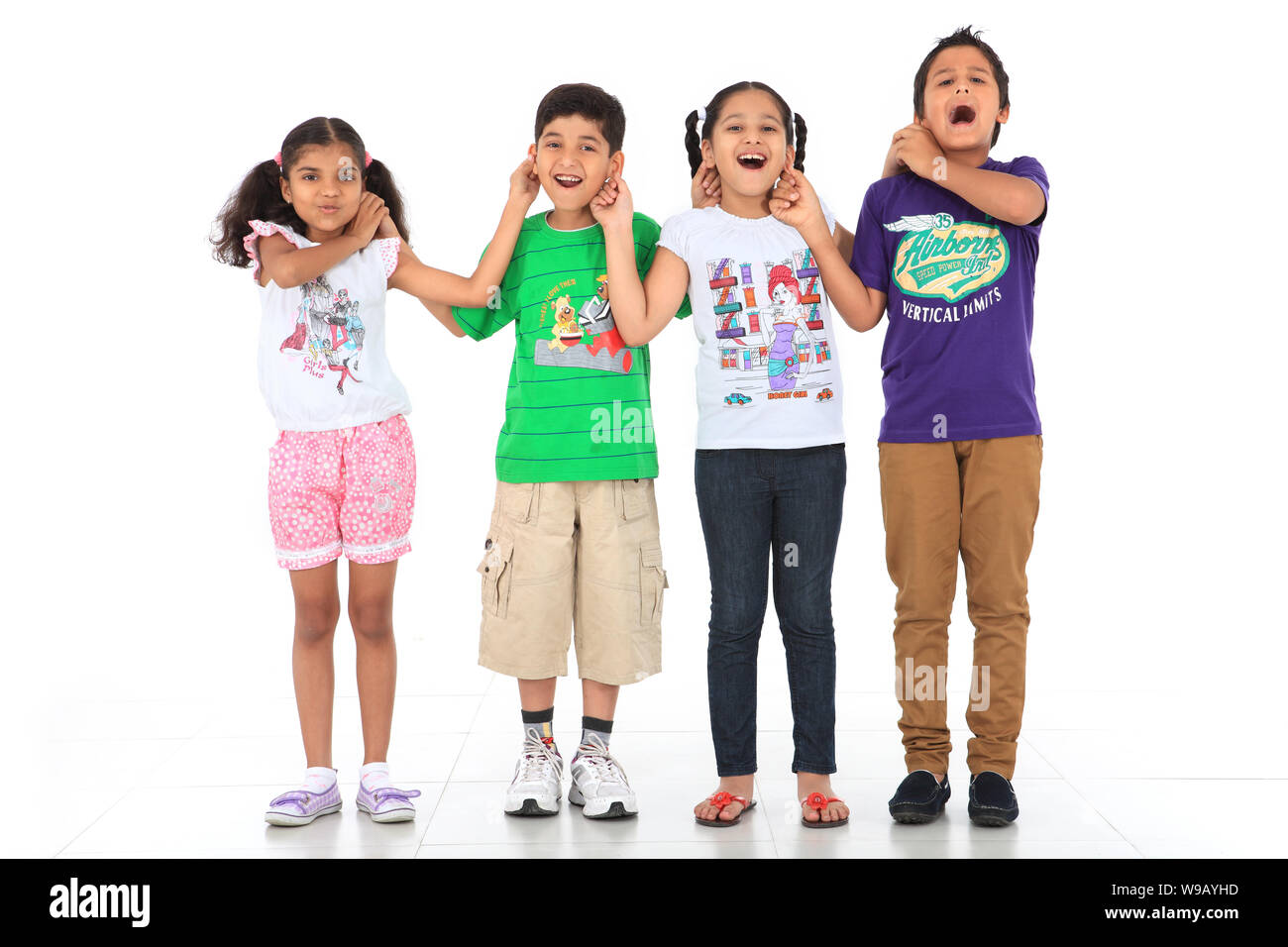 Gruppe von Kindern, die sich die Ohren ziehen Stockfoto