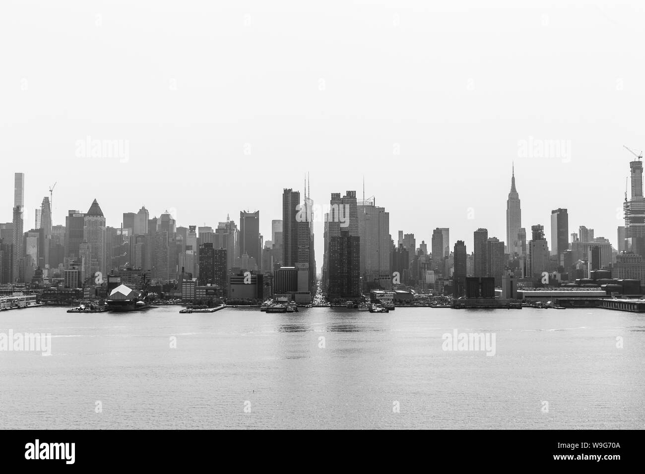 New York City Midtown Manhattan Skyline panorama Blick vom Boulevard East alte Herrlichkeit Park über den Hudson River auf einem nebligen Morgen. Schwarz-weiß-Bild. Stockfoto