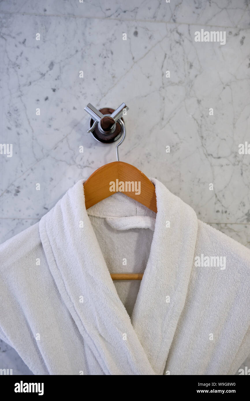 Sauberen, weißen Bademäntel hängend auf hölzernen Kleiderbügel Stockfoto