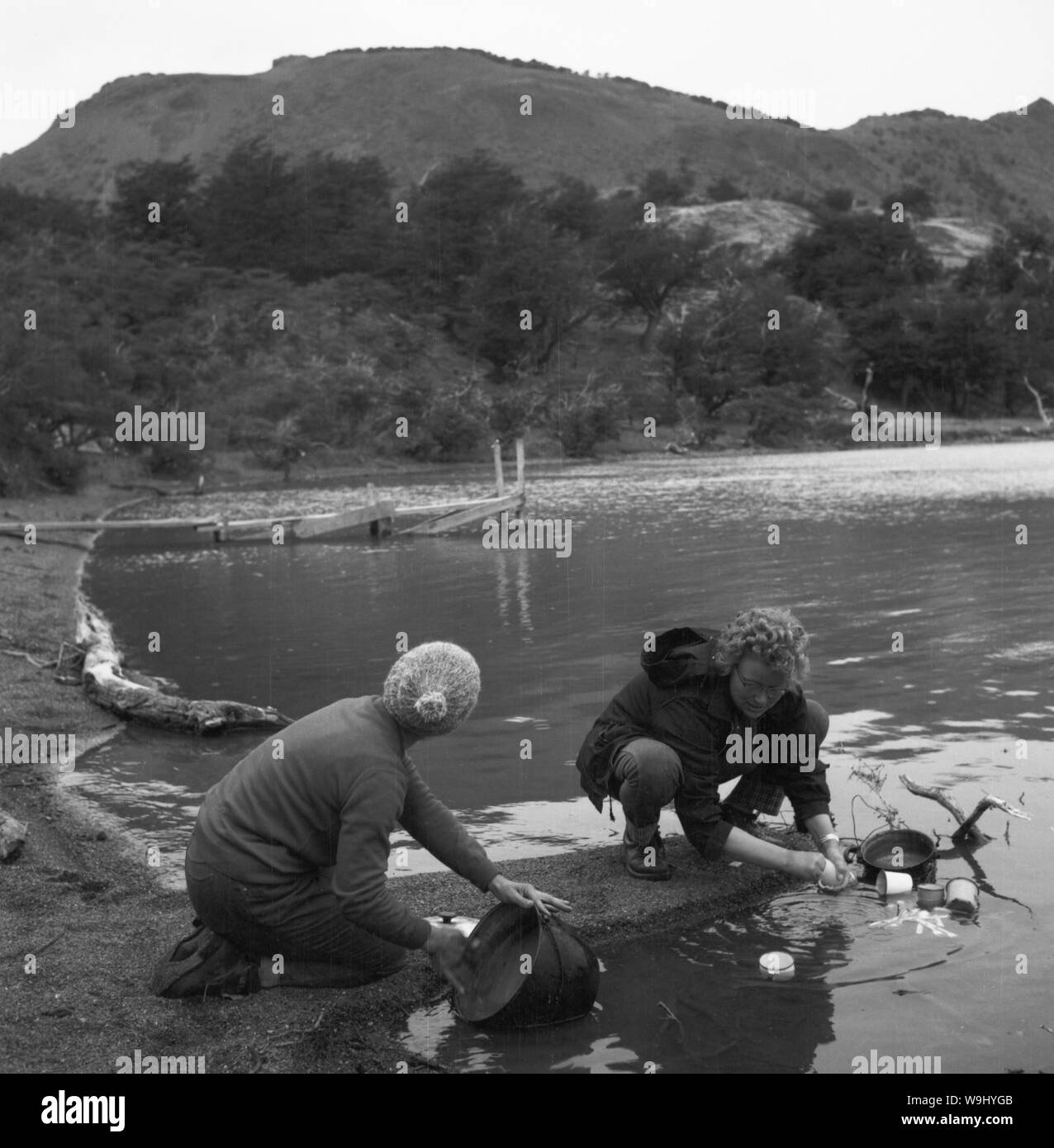 Fotografin Hanna Seidel (rechts) am Ufer der Laguna Amarga, im Hintergrund die Berge der Altos de Cantillana in Chile, 1960er Jahre. Fotograf Hanna Seidel (rechts) am Ufer der Laguna Amarga mit dem Altos de Cantillane im Hintergrund in Chile, 1960. Stockfoto