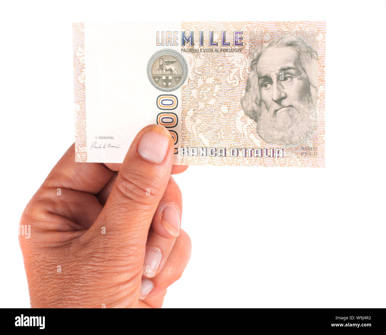 Hand mit Italienischen vintage Währung Banknote. Auf weiß. Stockfoto