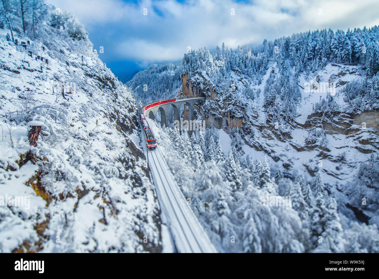 Bernina Express führt durch die verschneiten Wälder rund um Filisur, Kanton Graubünden (Graubünden), Schweiz, Europa Stockfoto