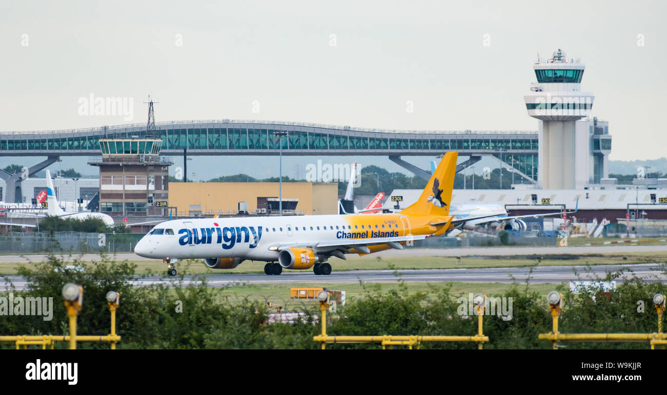 Die einzige Embraer 195 in der Flotte Aurigny Air Services Limited schaltet die Start- und Landebahn vor der Air Traffic Control Tower. Stockfoto