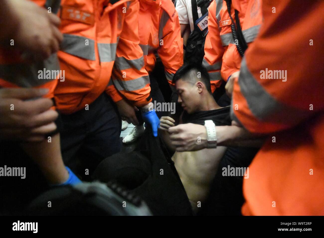 (190815) - HONGKONG, 15 August, 2019 (Xinhua) - Eine verletzte Tourist ist von den Sanitätern aus einer Einkesselung von gewaltbereiten Autonomen am Hong Kong International Airport in South China Hong Kong, Aug 13, 2019 begleitet. Zwei Monate auf, der Eskalation der Gewalt in Hongkong hat einen schweren Tribut von der sozialen Ordnung. Gewalttätige radikale verpflichtet, Vandalismus, blockiert der Fahrspuren, belästigt urbanen Pendler und Brände an. Viele haben sich für eine Bremse auf die krasse Gewalt und für die Ordnung wiederhergestellt werden. (Xinhua) Stockfoto