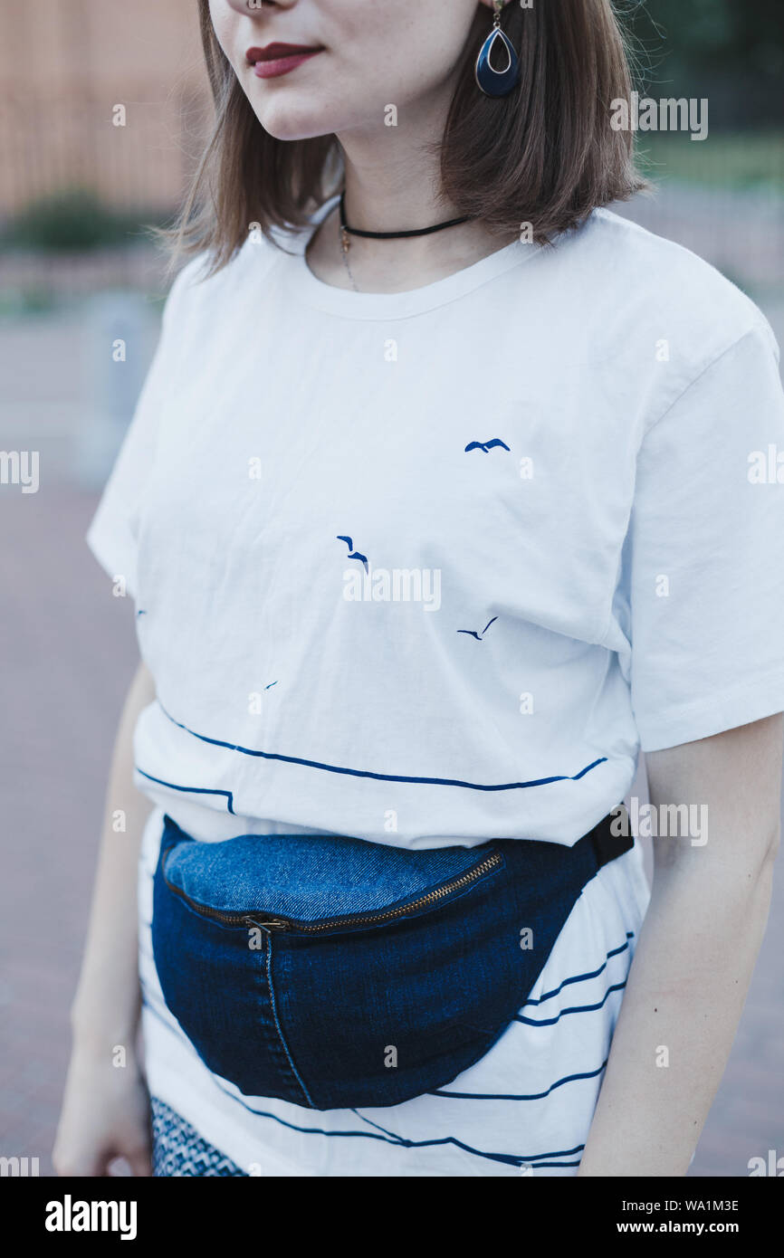 Trendy blau stilvolle Gürtel denim Tasche Kupplung auf junge Frau. Urban Street Style Stockfoto