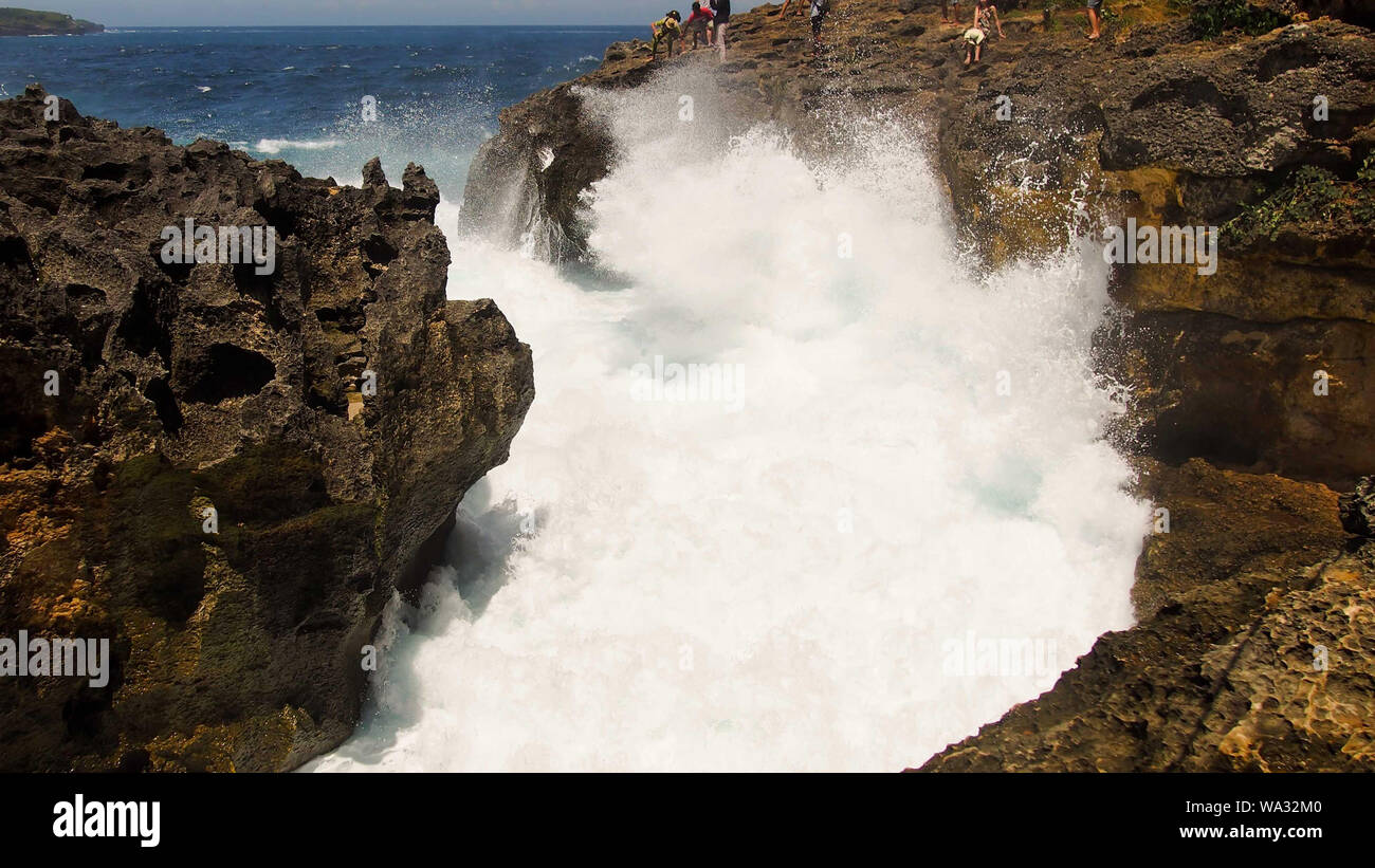 Meer mit Wellen spashing zu den beiden Felsen auf beiden Seiten. Weiß big Spritzwasser, Felsformationen Stockfoto