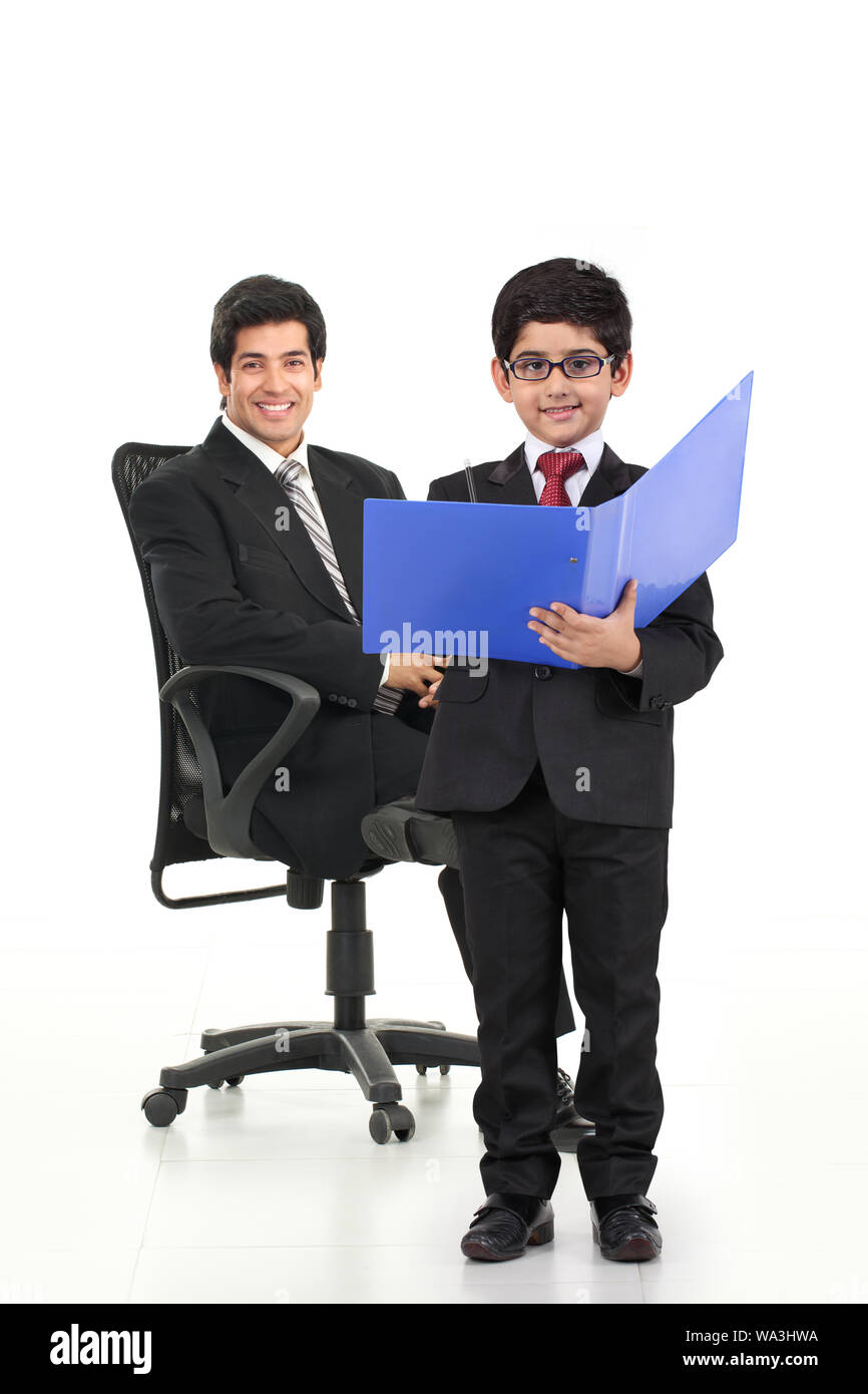 Junge imitiert als Geschäftsmann und steht mit seinem Vater Stockfoto